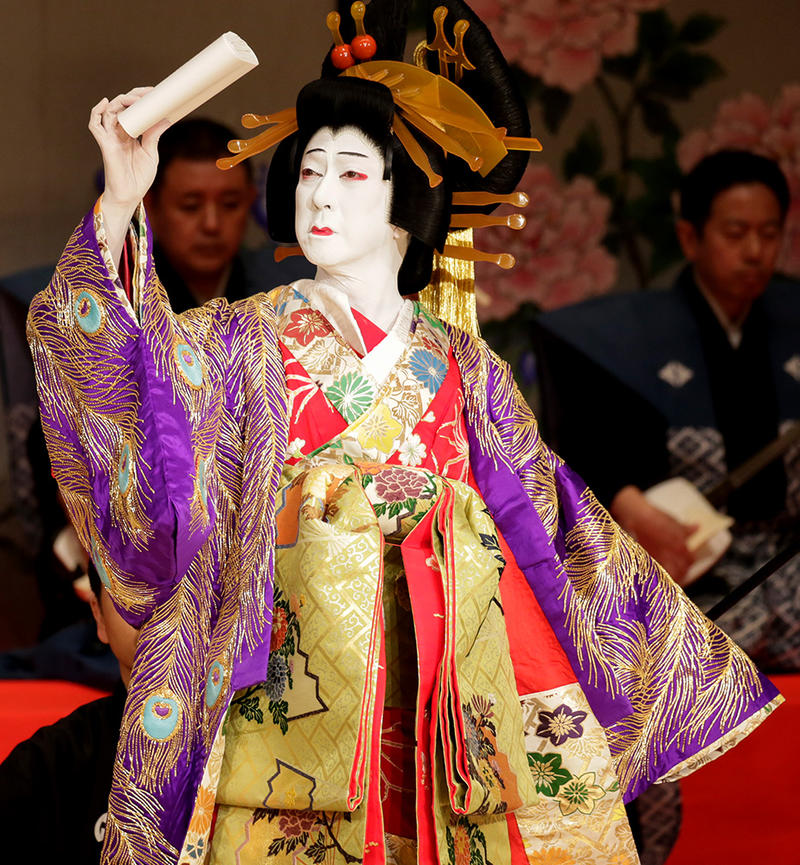 Kabuki kimono performer Kabuki performer in sumptuous costume with golds, peacock feathers and reds